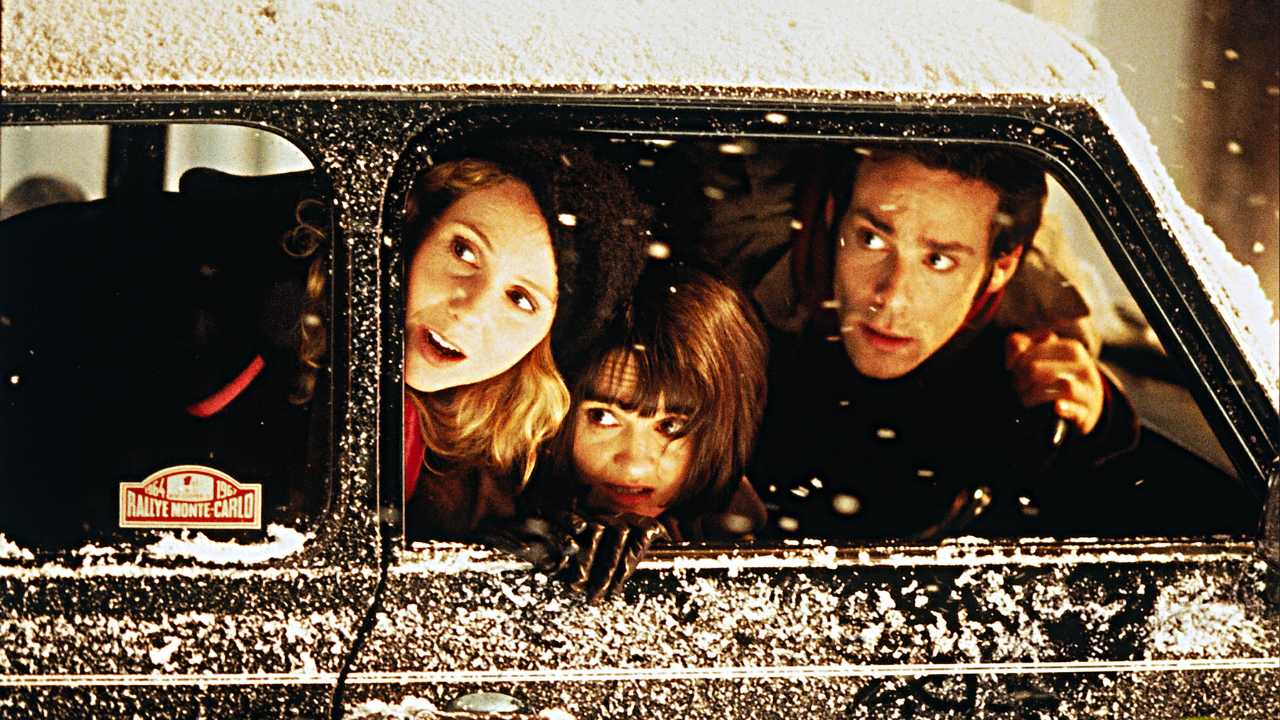 Three people looking out a car window